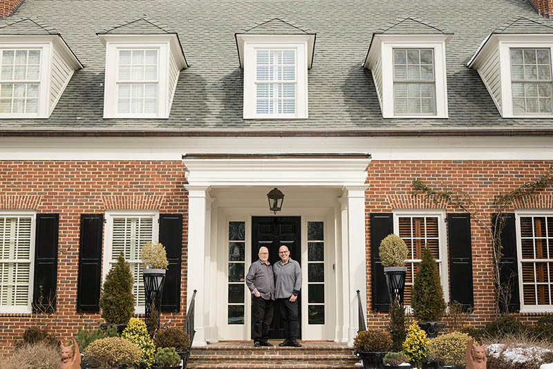 Richard and Brian, owners of Hidden View Farm, standing in front of the manor at Hidden View Farm a wedding and event venue in Annapolis, Maryland.